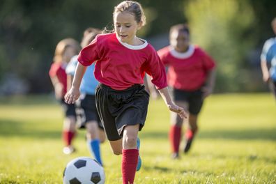 Stock image of a young girl playing soccer