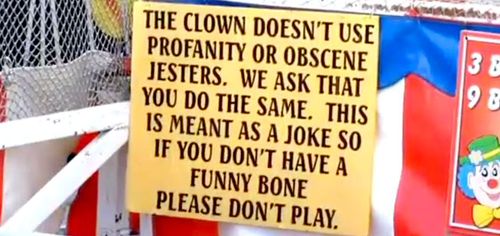 A sign at the clown's dunk tank assuring no profanities or obscene language will be used. (WMCA)