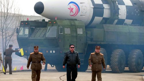 Kim Jong Un in front of missile