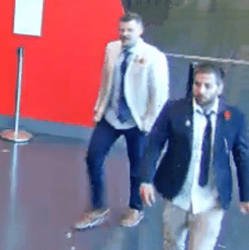 two men walking inside