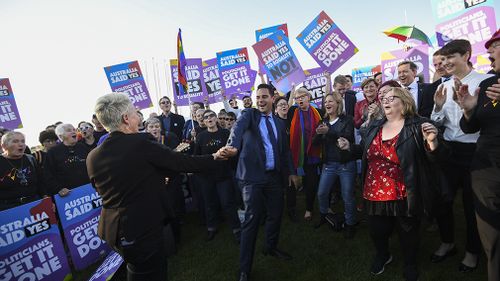 Same-sex marriage campaigner Alex Greenwich and Magda Szubanski dance outside Parliament House. (AAP)