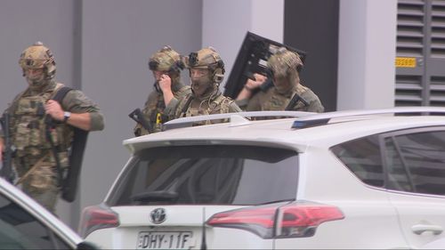Heavily-armed police in camoflage gear attended the scene.