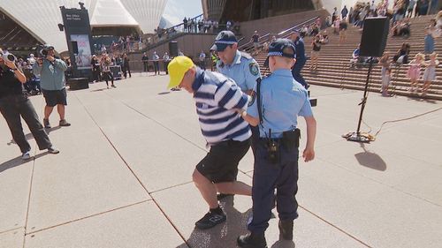 12-year-old Detective Bryson stands on the steps of the Sydney Opera House after solving the case.
