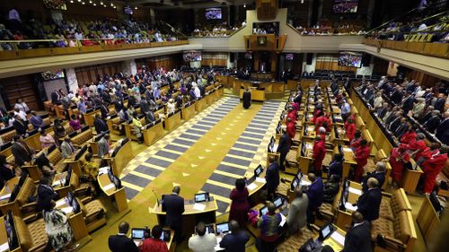 Parliament gathers for a swearing in ceremony for acting President of South Africa Cyril Ramaphosa, inside Parliament in Cape Town. (AAP)