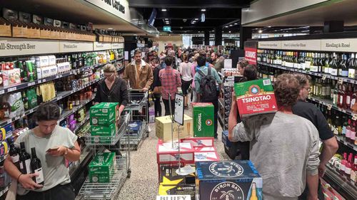 Checkout queues snake down the aisles at a Dan Murphy's in Brunswick late last month.