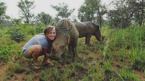 Laura Ellison poses with a rhino in South Africa. (Instagram / @lauraellison)