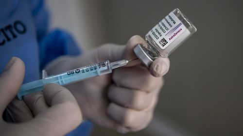 A healthcare worker of the Italian Army prepares doses of the AstraZeneca COVID-19 vaccine.