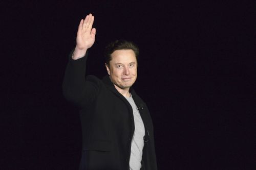 Elon Musk waves while providing an update on Starship, on Feb. 10, 2022, near Brownsville, Texas. Twitter on Thursday, Dec. 15, 2022, suspended the accounts of journalists who cover the social media platform and Musk.