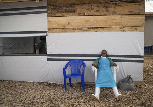 A health workers rests at the end of his shift at an Ebola treatment center in Beni, Congo.