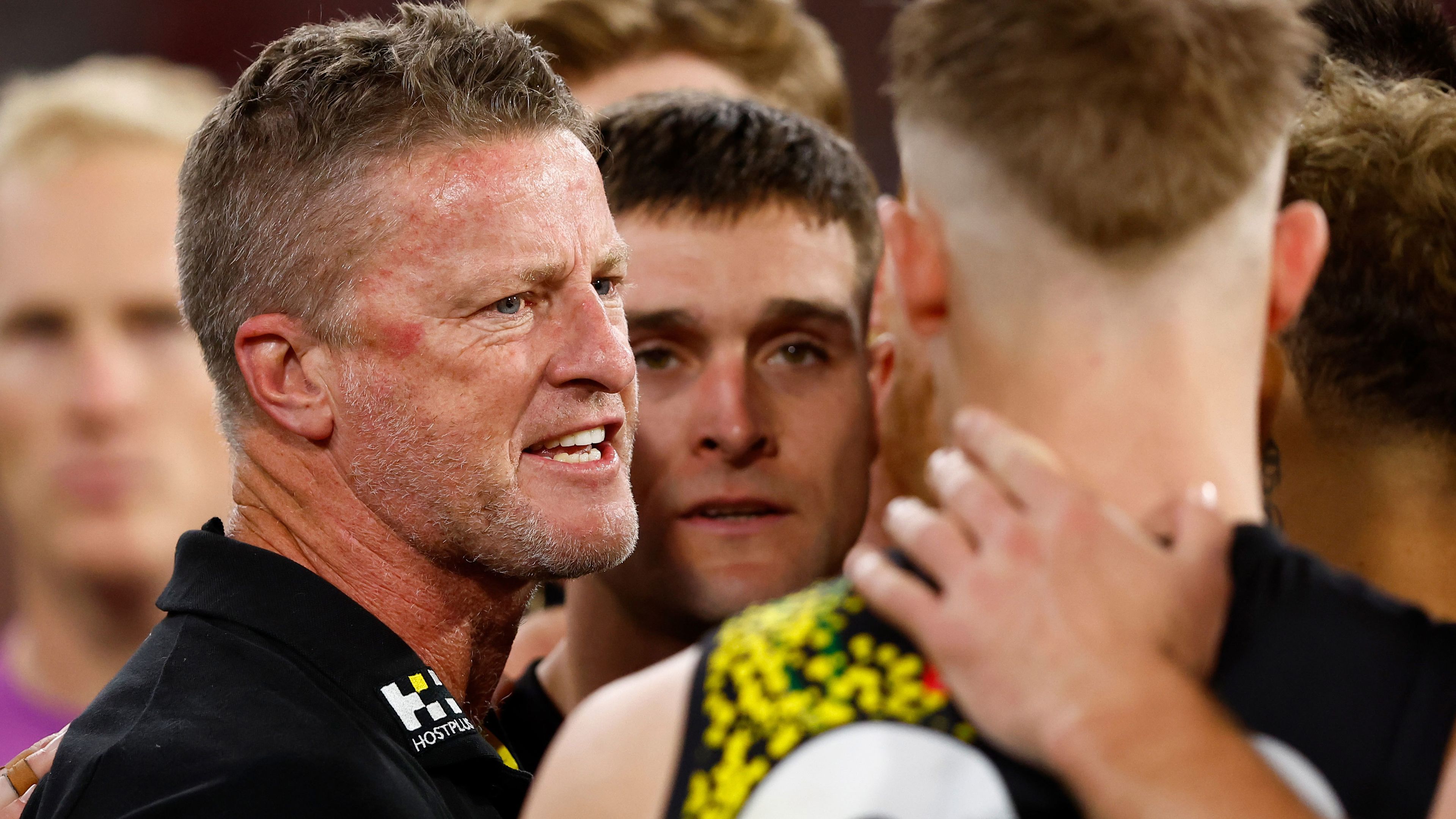 Damien Hardwick addresses Tigers players in a huddle during their match against the Melbourne Demons in April. 