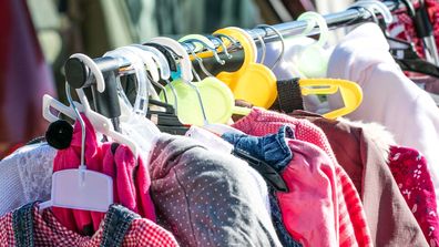 A rack full of second-hand children's clothing