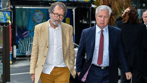 Australian director of theatre Neil Armfield (left) arrives at the Federal Court in Sydney, Wednesday, October 24, 2018.