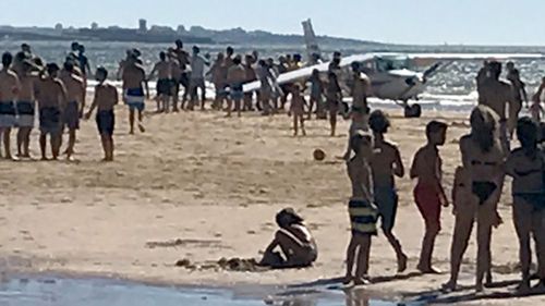 An image shared by local media purports to show the light aircraft forced to make an emergency landing on a beach in Portugal. (Supplied)