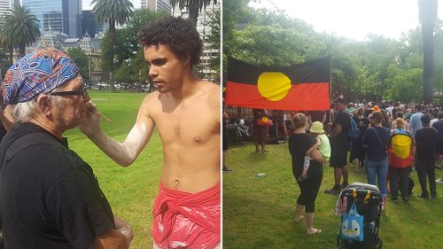 Protesters in Sydney painted their faces in traditional patterns and held up Indigenous flags in a march from Redfern (Supplied).