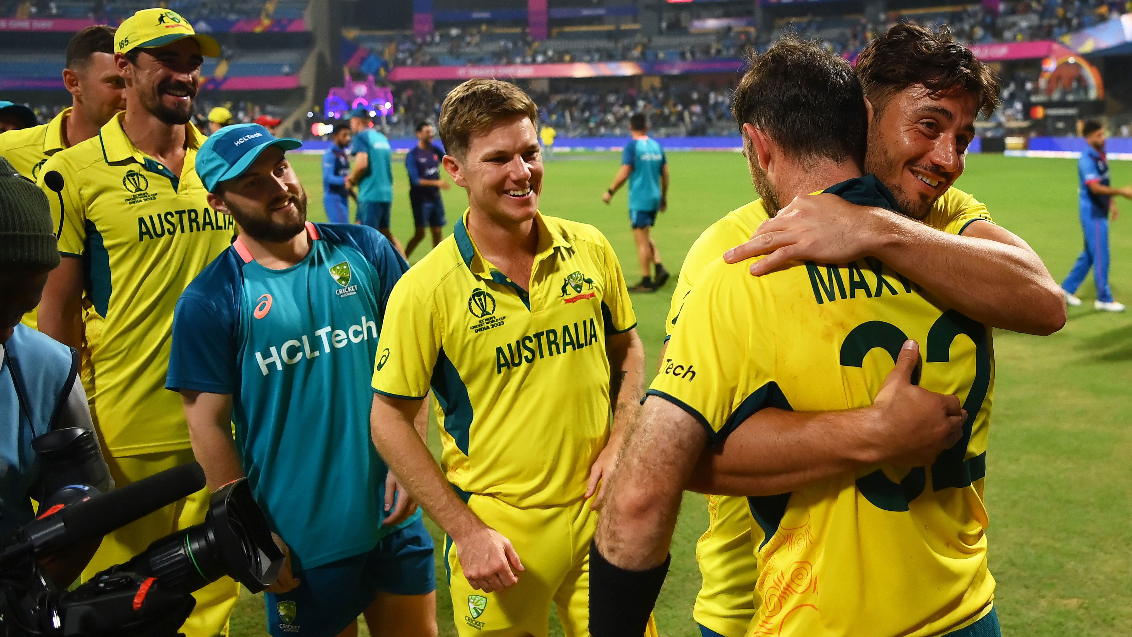 Marcus Stoinis gives Glenn Maxwell a congratulatory hug as Australia celebrate following a stunning win over Afghanistan.