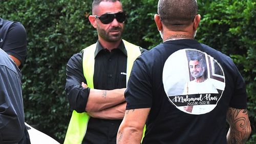 Mourners were dressed in black, some wearing shirts emblazoned with Hawi's image. (AAP)