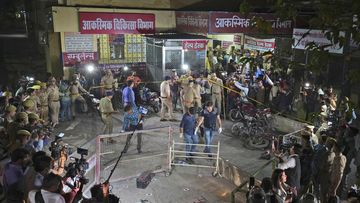 Police and media surround the area where  Gangster-turned-politician Atiq Ahmad and his brother Ashraf were shot in front of the Motilal Nehru medical college in, Prayagraj, India.