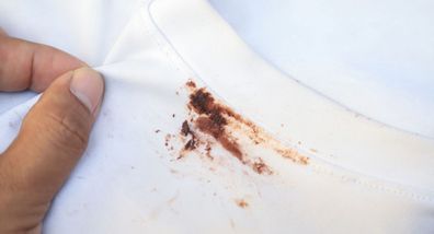 A chocolate stain on white clothing.