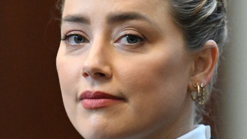 Actress Amber Heard listens in the courtroom.