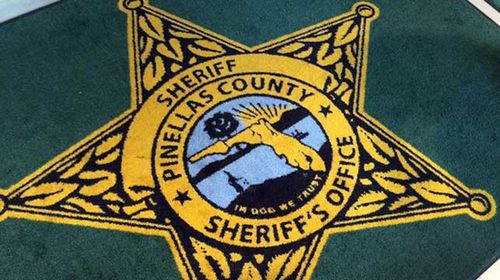 'In Dog We Trust' rug at County Sheriff's office in Florida. 