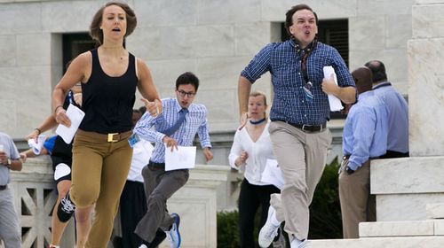 Since they cannot take mobile phones into the US Supreme Court with them, TV reporters wait outside as their interns sprint the 100m between the building and the cameras. With the gay marriage ruling perhaps the most significant court decision in perhaps decades, today's interns were all the more keen to be the first to get to their bosses. (AAP)