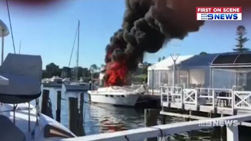 A boat exploded into flames today next to the Lake Macquarie Yacht Club, north of Sydney. Picture: Supplied.