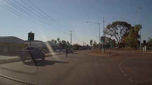 After the near-miss, the cyclist then continues riding and joins in the queue of vehicles. Picture: Facebook