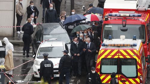 France's Prime Minister Jean Castex, centre, arrives at the scene of a knife attack near the former offices of satirical newspaper Charlie Hebdo, Friday September 25, 2020 in Paris