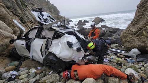 This photo provided by the San Mateo County Sheriff's Office shows emergency personnel responding to a vehicle over the side of Highway 1 on Sunday, Jan. 1, 2023, in San Mateo County, Calif.