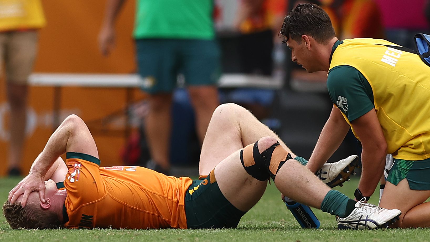 Henry Hutchinson of Australia receives medical attention after an injury during the 2023 Sydney Sevens.