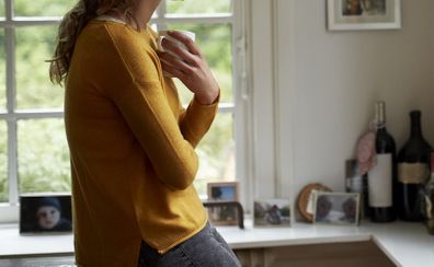 Woman drinking coffee at home