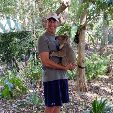 Rob Riggle poses with a koala at Lone Pine Koala Sanctuary in Queensland