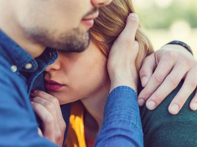 Man comforting woman