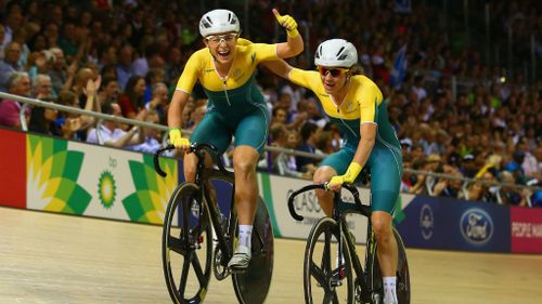Annette Edmondson and Amy Cure cheer after they cross the finish line of the 10km scratch race in first and second place at the Glasgow Commonwealth Games. (Getty)