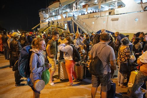 Thousands of tourists have been left to fend for themselves, seeking out boats away from the island or staying in the Lombok Airport. Picture: AAP.