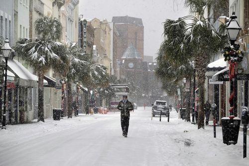 A person walks in the snow on King Street in Charleston, South Carolina during the week. (AAP)