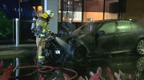 A teenage fast food worker has been treated for smoke inhalation after a luxury car ignited in a McDonald's drive-through south of Brisbane.The car caught fire while the worker was ordering food at the Eagleby restaurant shortly after midnight on Sunday. 