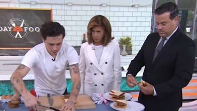 Brooklyn Beckham makes a bacon, sausage and egg sandwich during a cooking segment on the US Today Show