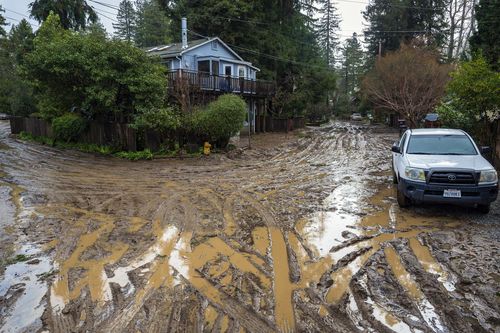 Muddy streets in the Felton Grove neighborhood of Felton, Calif., Tuesday, Jan. 10, 2023.