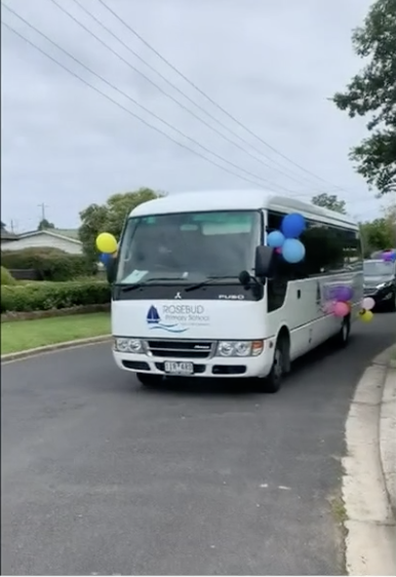 Decked out in balloons, and a loudspeaker, a convey of vehicles drove past students' homes.