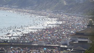 People are seen on Bourenmouth beach on the hottest day of the year.