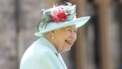 Britain's Queen Elizabeth smiles after awarding Captain Sir Thomas Moore his knighthood during a ceremony at Windsor Castle.