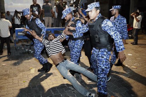 An opposition protester is arrested by police after street clashes. Picture: AAP