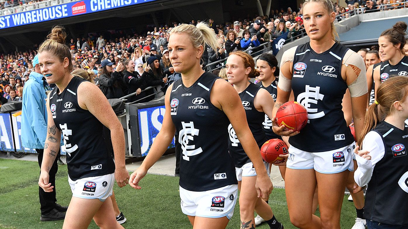 Blues players walk onto the field during the AFLW Grand Final match between the Adelaide Crows and Carlton Blues at the Adelaide Oval