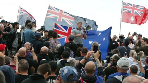 Convicted criminal Blair Cottrell (centre, with megaphone) was one of the organisers.