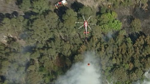 An RFS helicopter and 20 firefighters are battling the blaze. (9NEWS)