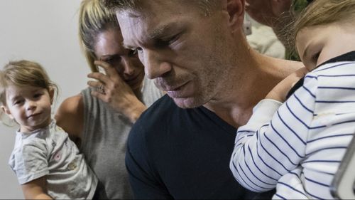 Warner arrived back in Sydney on Thursday night with his wife and young daughters after being dumped as vice-captain of the Australian cricket team after being accused of masterminding the ball tampering plot. Picture: AAP.