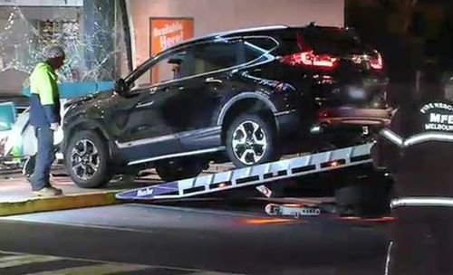 The man allegedly rammed his car into the servo after a woman, with facial injuries, ran inside for refuge. 