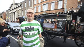 Tomas, no surname given, who travelled from Sweden to attend the funeral, stands on Westland Row as the funeral procession of Shane MacGowan makes its way through the streets of Dublin, ahead of his funeral in Co Tipperary, in Ireland, Friday, Dec. 8, 2023.  