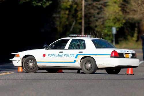 A police vehicle is parked at a crime scene in Portland